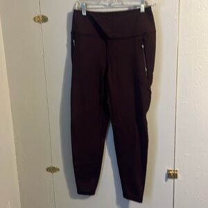 Spyder Active fleeced lined leggings size medium in color maroon red.